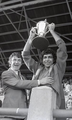 Dempsey holds the 1975 premiership cup aloft.